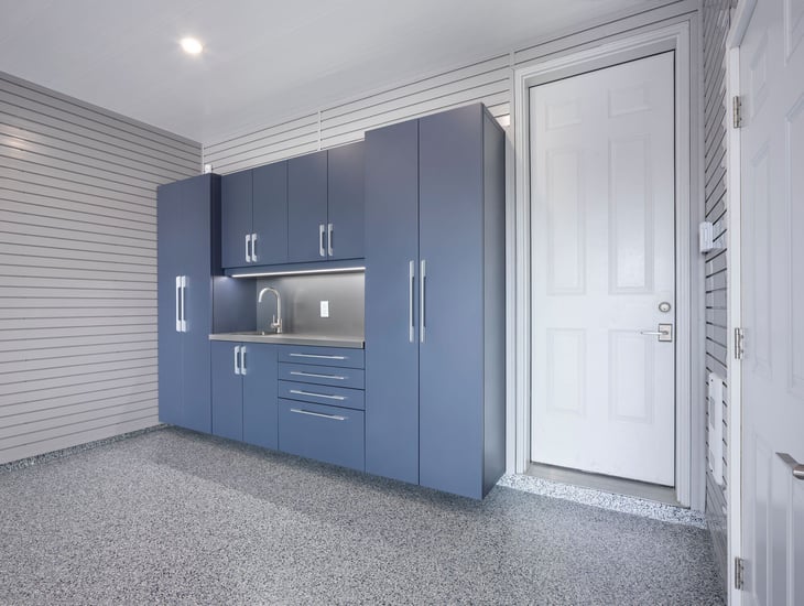 This garage features a good balance of shelf and wall storage, along with cabinetry.