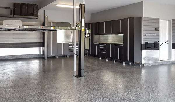 Garage makeover after Garage Living car lift flooring sleek cabinetry specialty storage racks